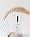 Renew Retinol Serum on wood stand with pretty light pink decor