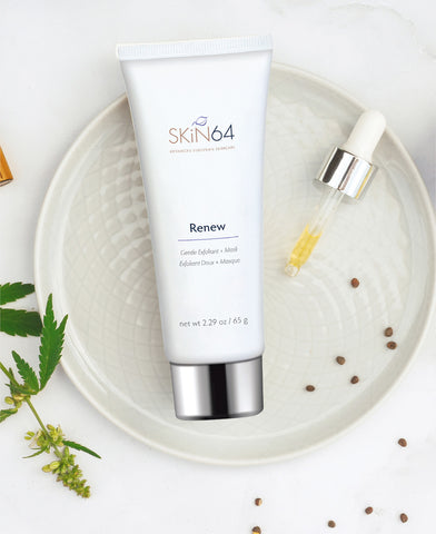 Renew exfoliant + mask on a white dish surounded by natural ingredients